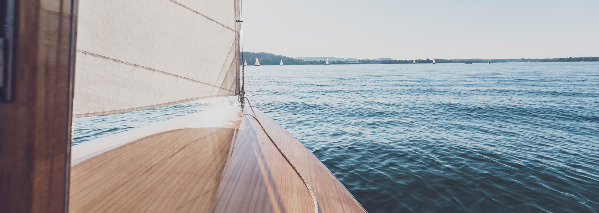 Image from sailboat looking out to the ocean in front of the watercraft